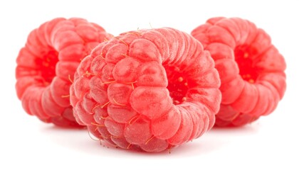 Close-up view of three fresh raspberries.