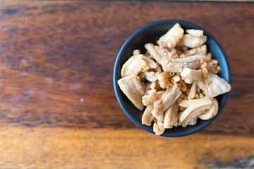 Deep fried pork skin. The hard part of pork is fried to make lard, and then the residue is separated. In Thailand, pork rinds are popularly used in various dishes such as boat noodles