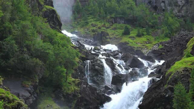 The Låtefossen in the green mountain running down, Norway, travel experience
