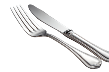 Polished silver fork and knife angled, ready for a meal