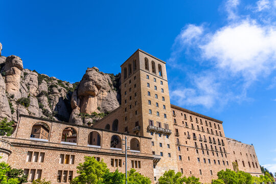 Close view of Santa Maria de Montserrat Monastery on Montserrat Mountain on a sunny spring day, Monistrol de Montserrat, Catalonia, Spain