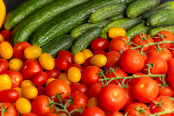 Fresh cucumbers, red and yellow tomatoes creating a colorful composition