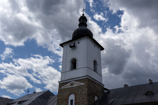 bell tower of a monastery in romania against a cloudy sky