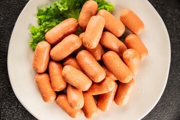 Mini sausages fresh delicious processed meat tasty snack fresh delicious gourmet food background on the table rustic food top view copy space