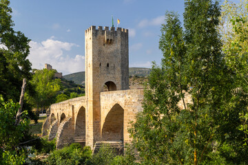 Obraz premium Fortified medieval bridge over the Ebro River in Frias, Spain, featuring a defensive tower