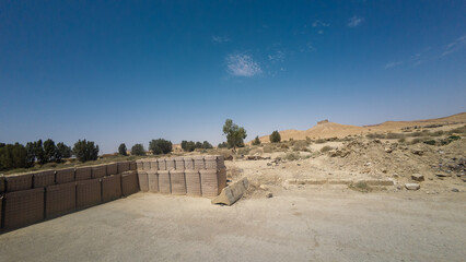Desert Landscape with Sandbags and Clear Sky
