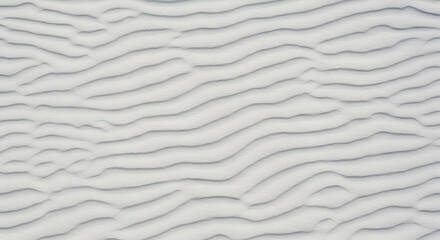 Obraz premium Serene White Sand Dune Texture: Subtle Undulating Lines, Minimalist Beach Background, Natural Pattern, Calm and Peaceful Mood.