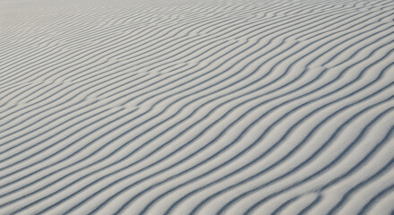 Obraz premium Serene White Sand Dune Texture: Subtle Undulating Lines, Minimalist Beach Background, Natural Pattern, Calm and Peaceful Mood.