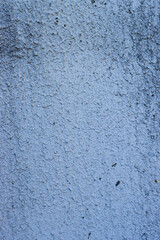 Vertical photo of a blue concrete wall.