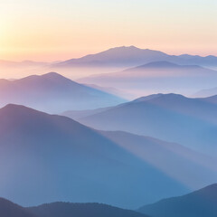 Obraz premium Misty mountain range at sunrise with soft pastel colors and atmospheric light rays.