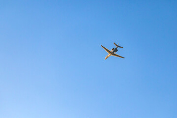 Private jet flying in blue sky over Hostivice, Czechia