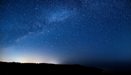 Fototapeta premium a stunning night sky filled with bright twinkling stars against a dark blue background creating a serene and peaceful atmosphere