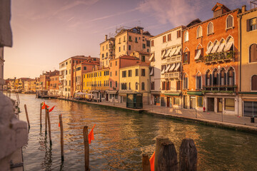 Venetian canals with colorful houses and boats in Venice Italy