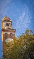 Historic Venetian bell tower with clock under blue sky
