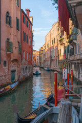 Narrow Venetian canals with colorful historic buildings and gondolas