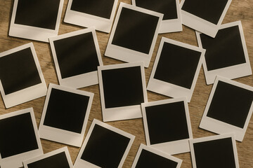 A Vintage Collection: Blank Instant Photos on a Wooden Surface