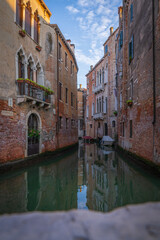 Venetian canal with boats and historic facades