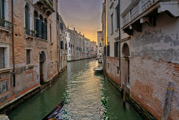 Venetian canal at sunset with historic buildings