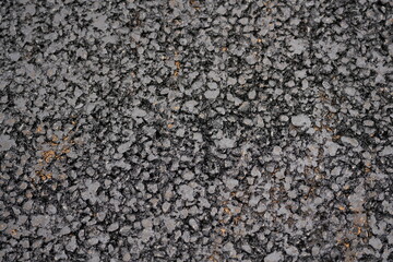 Fresh asphalt road surface texture with visible stones and bitumen, construction and infrastructure background
