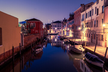 Fototapeta premium Illuminated canal in Venice with reflections