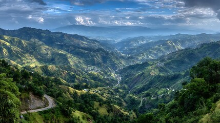 A breathtaking view of a lush, green mountain range with a winding road cutting through it, under a cloudy sky.