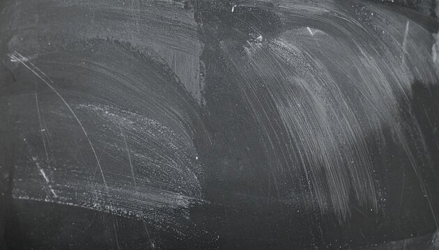 Grungy black chalkboard surface with smeared white chalk residue and abstract texture