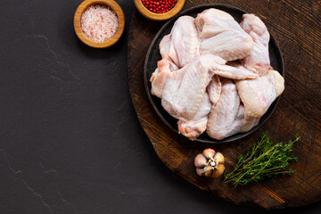 Raw chicken wings and spices before cooking top view copy space for text