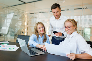 Fototapeta premium Collaboration and teamwork people in a modern office among professionals reviewing project data and discussing strategies