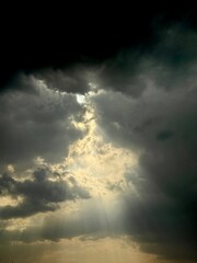 Dramatic Sunlight Breaking Through Storm Clouds in Spanish Sky