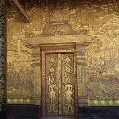 Golden Buddhist art in an ancient temple in Luang Prabang, northern Laos