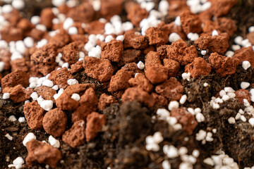 rich organic potting soil with perlite and clay pebbles, perfect for gardening, plant growth, agriculture, horticulture, composting, and sustainable eco friendly farming projects. texture of nutrient.