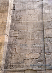 Ancient wall reliefs of Sekhmet and Isis at the Temple of Philae in Aswan