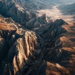 A breathtaking aerial view of a rugged, rocky landscape with deep canyons and dramatic cliffs