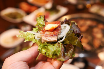 Korean bbq. ssam : eat pork wrapped in lettuce leaves