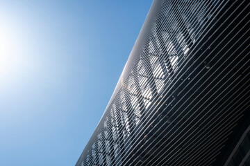 Modern Architectural Facade Reflecting Sunlight under a Clear Blue Sky