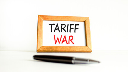 Trade tariff war symbol. Concept word Tariff war on beautiful wooden picture frame. Black pen. Beautiful white paper background. Business trade tariff wars concept. Copy space.