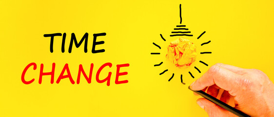 Time change symbol. Concept word Time change on beautiful yellow paper. Businessman's hand. Light bulb icon. Beautiful yellow paper background. Business time change concept. Copy space.