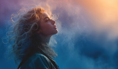 Romantic blonde thoughtfully looks at the sunset, slightly raised her head, romantic atmosphere