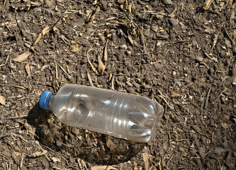 A photorealistic close-up of dry, dusty soil typical of a recently parched lawn or garden during a heatwave. The soil has small cracks and loose, fine dirt particles scattered naturally.