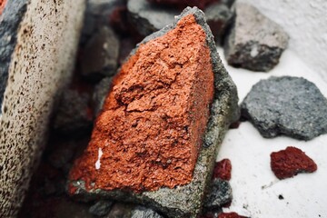 Broken Red Brick Piece on Concrete