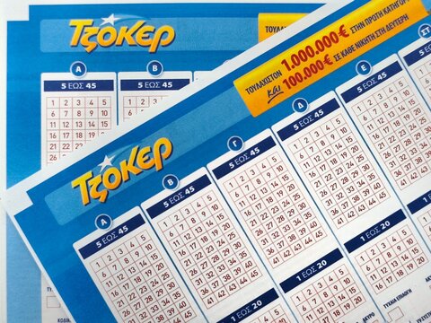 Closeup view of three Greek Tzoker lottery sheets, the leading game by OPAP where players pick numbers for jackpots drawn every Thursday and Sunday.