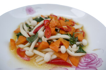 Stir-fried mushrooms with basil Delicious carrots and mushroom stir fry, plated. Fresh and appetizing a vegetarian dish