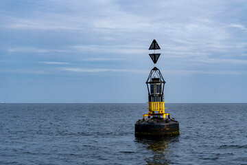 A Cardinal Marks buoy near the harbour in Penzance, Cornwall, UK
