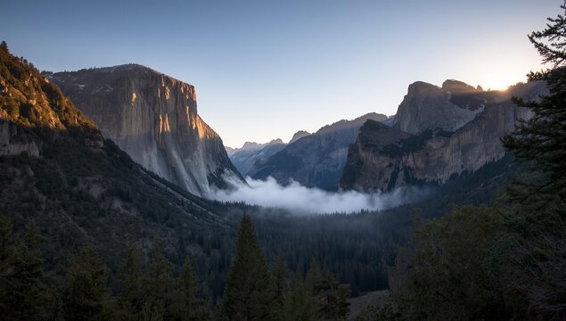 Dramatic Yosemite Valley sunrise bathes El Capitan in golden light with misty clouds below - Powered by Adobe