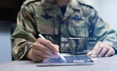 soldier man use stylus pencil to check program of radar and radio aviation for test system of tracking and defense at the dark control room center in monitor station for military technology concept