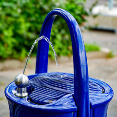 A public drinking water dispenser on a street in Berlin, Germany.