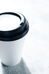 Coffee cup on the table, minimalistic design, disposable tableware, daylight,