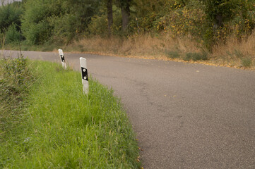 Delineators marking the edge of a winding country road