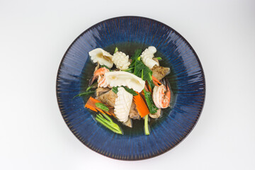 Rad Na Talay or Fried Noodles with Seafood Which consists of squid and shrimp in Thick Gravy Sauce on white background , Thai Style food