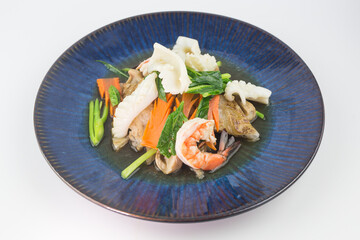 Rad Na Talay or Fried Noodles with Seafood Which consists of squid and shrimp in Thick Gravy Sauce on white background , Thai Style food